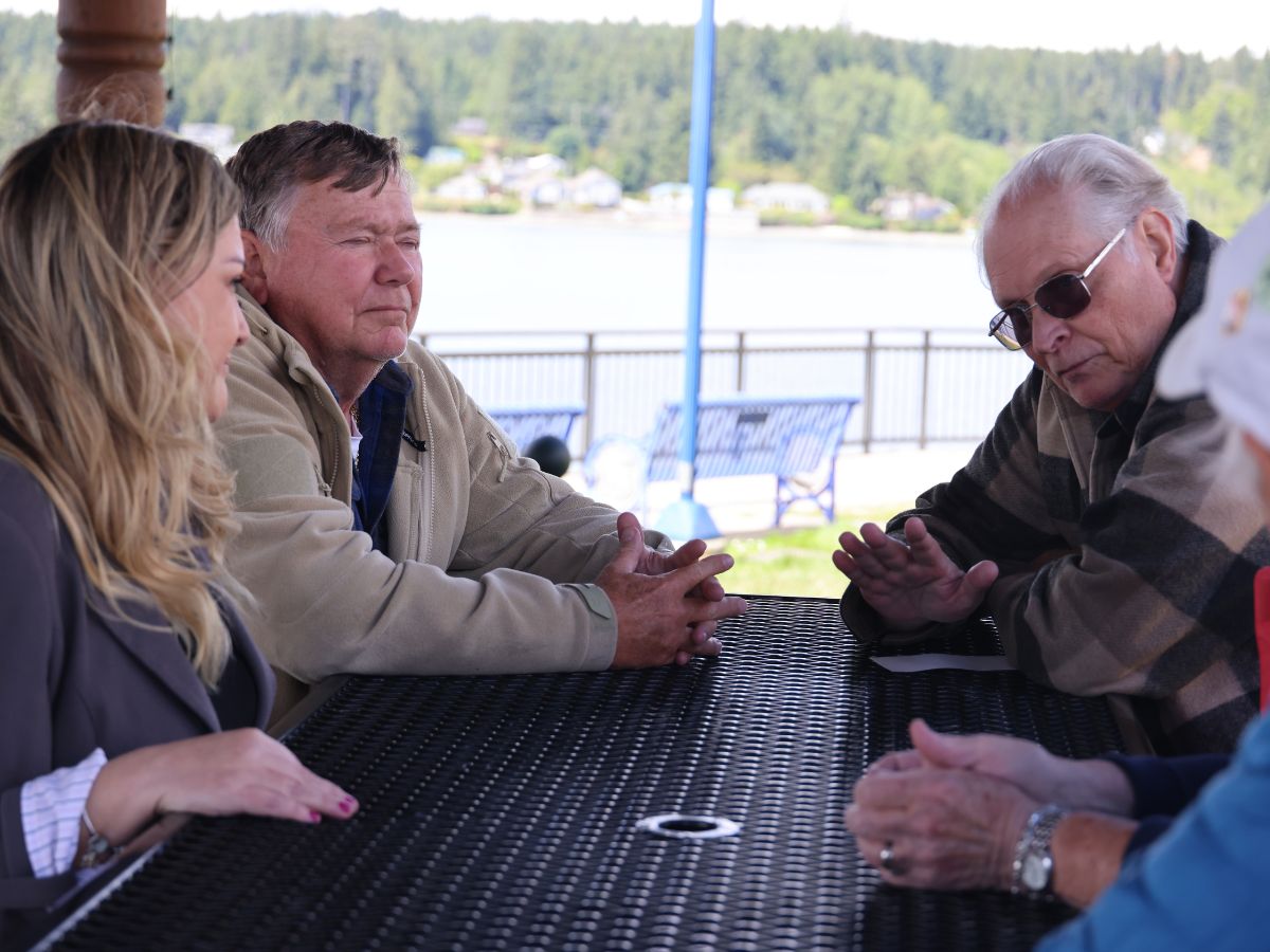 Tarra Simmons at a picnic table with city leaders along the waterfront.