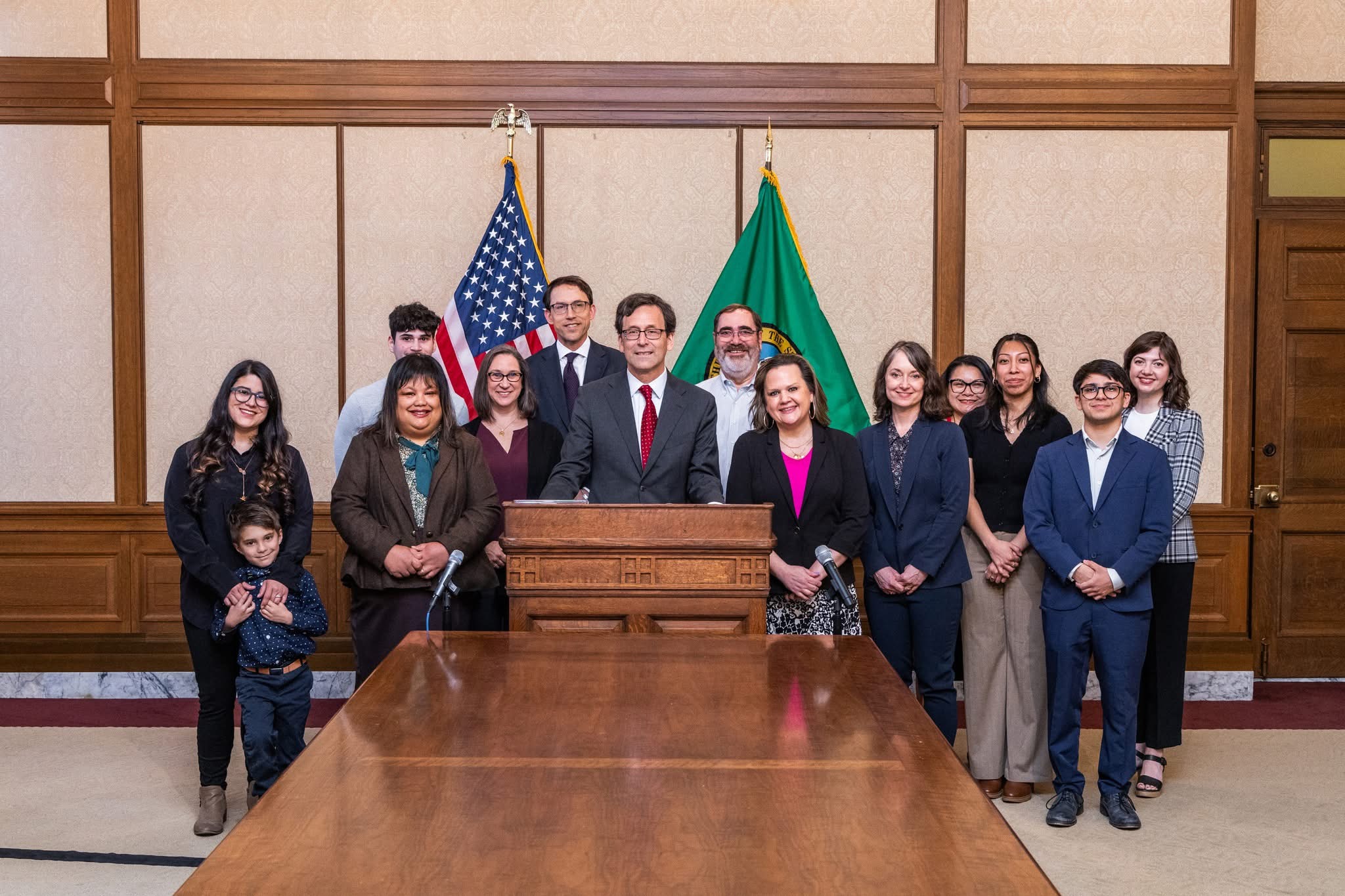 Tarra Simmons with legislators, community leaders, advocates, and Governor Ferguson at a bill signing