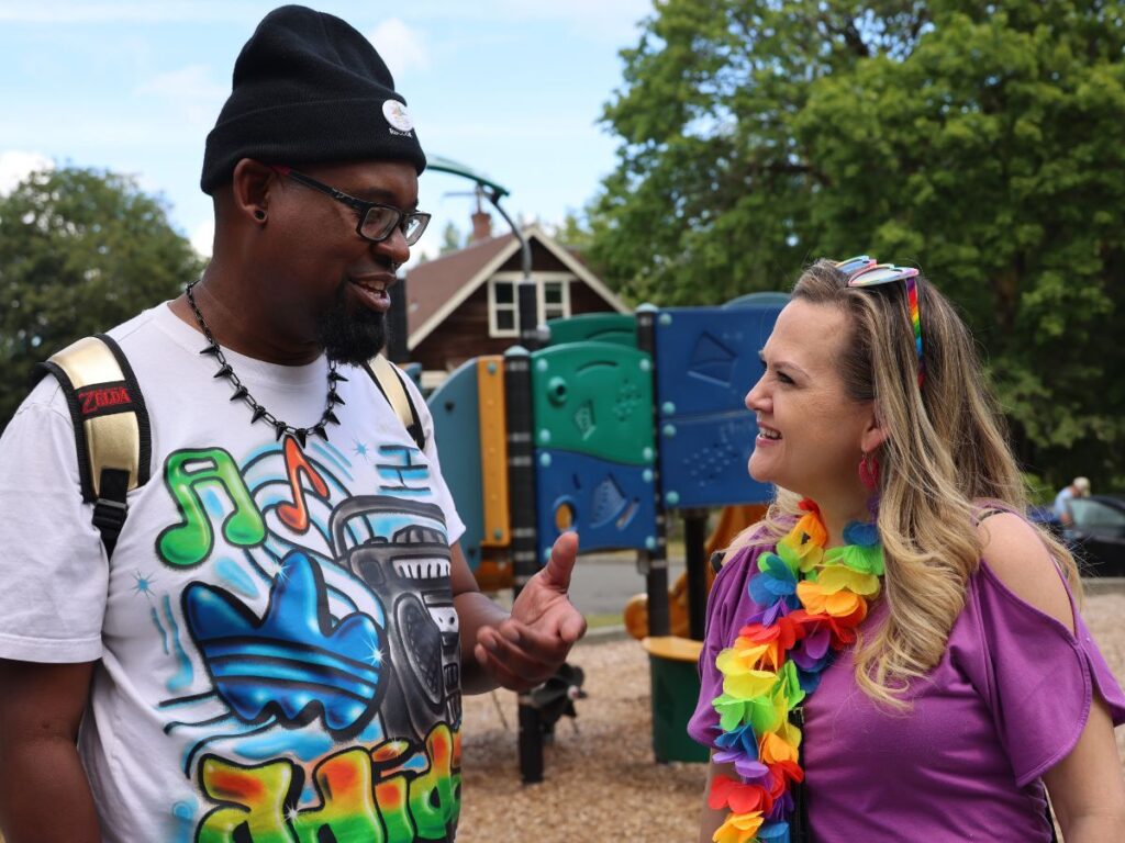 Tarra talking with a community member at a park
